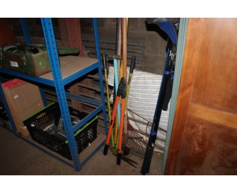 A bundle of long handed gardening tools