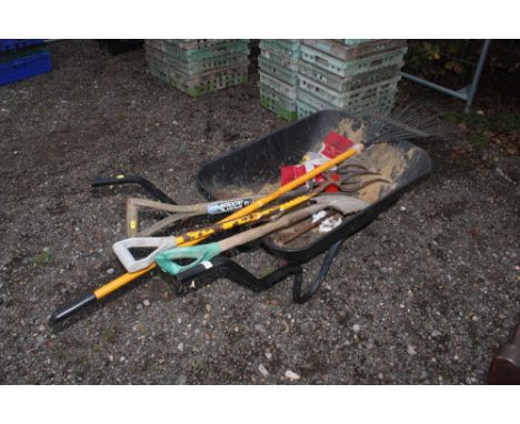 A garden wheelbarrow and contents of gardening tools 