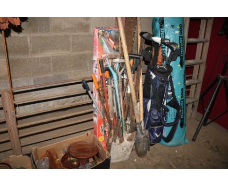 A large quantity of tools; to include large vintage saw, sash clamp, post hole digger