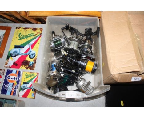 A box containing various fishing reels; to include Abu Garcia multi-plyers and a box containing small tackle