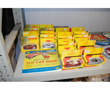 A quantity of Sports Car Classic die cast vehicles and a jar of Chapman Britains Toy Car Wars book