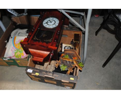 A box containing wall clock, cuckoo clock and various other clocks