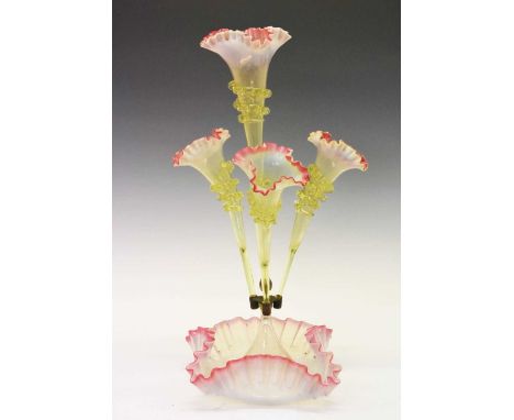 Vaseline and glass epergne, the four flower holders with crimped rim raised on conforming frilled base, 55cm high