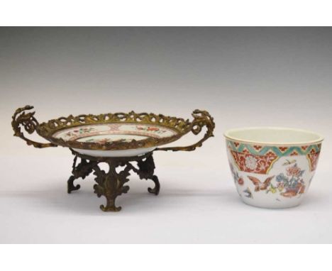 Late 19th Century Continental tazza or comport, composed of Chinese Famille Rose porcelain plate in pierced gilt metal foliat