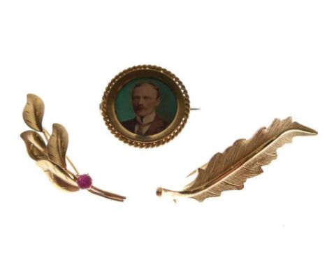 9ct gold leaf design brooch set a ruby, and two unmarked yellow metal brooches, 11g gross approx (3)
