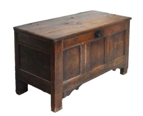 Oak three panel coffer, rectangular hinged plank top over three panel front raised on end stiles, 130cm x 57cm x 76cm high