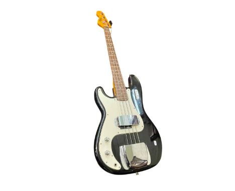 Vintage P Bass guitar and two electric guitars.