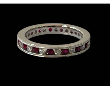 Diamond and ruby 9 carat white gold eternity ring, size N.