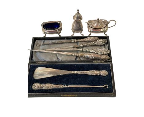 Silver three piece condiments and silver handled button hooks, shoe horn and glove stretchers.