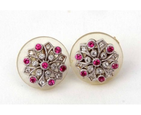 Pair of 18ct white gold and ruby diamond cluster earrings, of flower head design with seven small rubies interspersed by twel