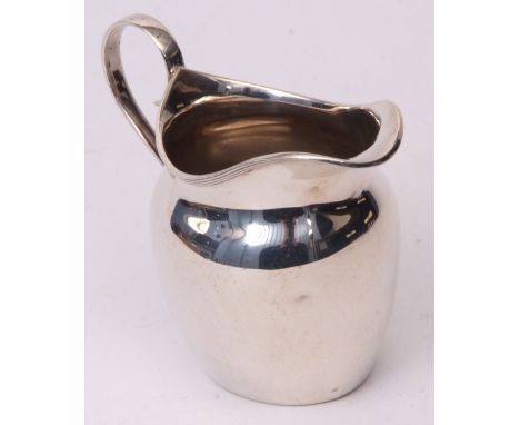 George V cream jug of helmet form with applied reeded rim and strap work handle, width 9 1/2cms, weight approx 69gms, Birming