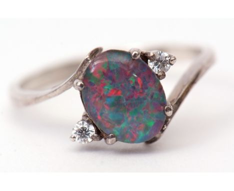 Opal cross-over ring, the central oval cut opal flanked by two brilliant white stones, stamped 925, size M  