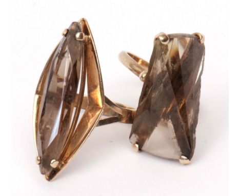 Two 9ct gold and smoky quartz designer rings, the lozenge shaped faceted stones claw set and raised in angular mounts, hallma
