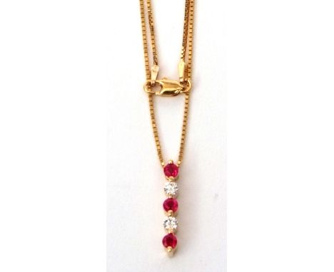 Modern diamond and ruby pendant featuring 3 round rubies and set with 2 round brilliant cut diamonds, 20mm long, stamped 14K,