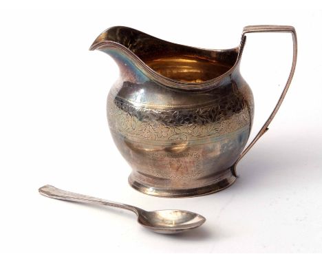 George III helmet shaped milk jug of oval form with engraved body and applied reeded rim and handle to a gilt lined interior,
