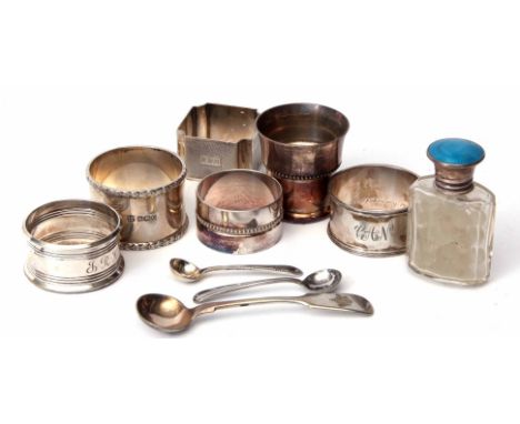 Mixed Lot: four various hallmarked silver napkin rings, together with a silver and enamel lidded clear cut glass toiletry bot