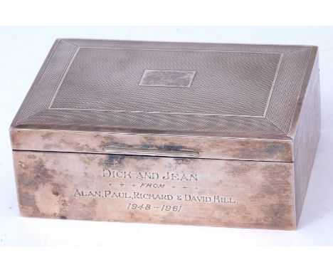 Elizabeth II cigarette box of hinged rectangular form with engine turned cover with central vacant cartouche and polished bod