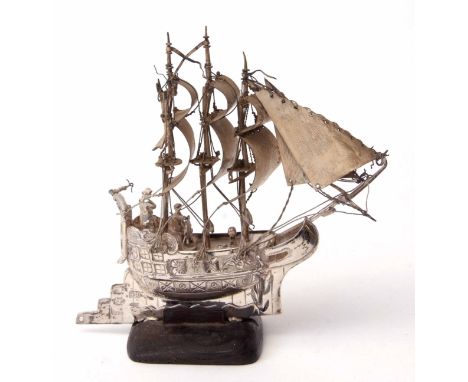 Continental white metal model of a three-masted sailing ship, stamped 930 and with further character marks, and raised on a s