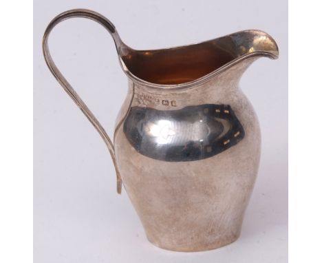 George V cream jug of helmet form with gilt lined interior, applied reeded rim and handle, height 10cms, weight approx 77gms,