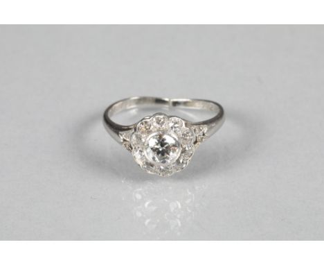 Ladies diamond cluster ring, daisy form with a central 0.5 carat diamond surrounded by small old cut diamonds, unmarked white