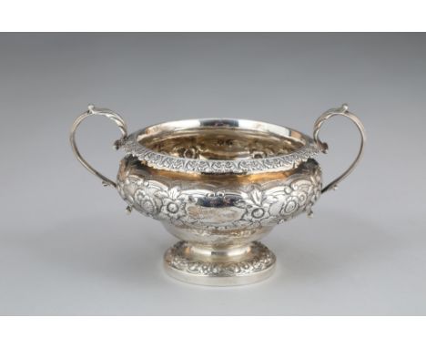 George IV silver sugar basin, twin acanthus leaf capped scrolled handled, embossed floral decoration.  Assay marked London 18