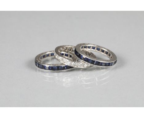 Set of three white gold eternity rings, one with a full band of diamonds the other two rings set with full bands of sapphires