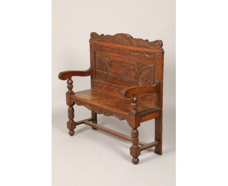 Carved oak bench, floral back panel, scroll arms with turned back supports 99cm long 46cm wide 110cm high