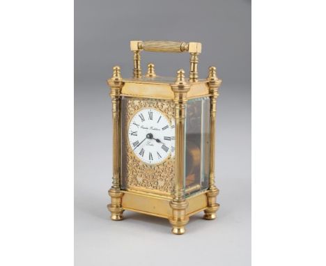 Brass carriage clock by Charles Frodsham, London, mid 20th Century, circular white dial with Roman numerals with a gilt scrol