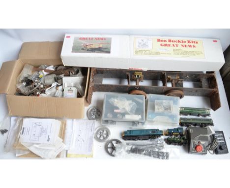 Partially built G gauge steam locomotive with a box of parts, radio control transmitters, books, magazines, DVD sets, OO gaug