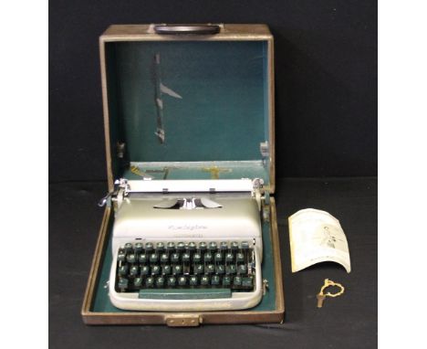 REMINGTON TYPEWRITER - a vintage Remington Travel-Riter in original case with key.