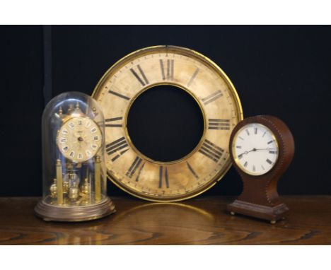 CLOCKS - a Brevett balloon clock (not currently working) and a Koma Anniversary clock. Lot includes a wall clock dial. (3)