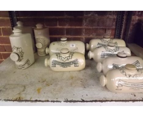 SHELF OF 9 DOULTONS IMPROVED FOOT STONE WARMERS BY THE LAMBETH POTTERY LONDON