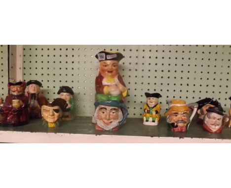 SHELF OF VARIOUS CHARACTER JUGS