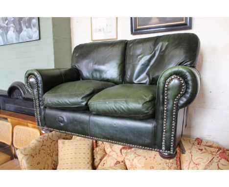 An early 20th Century leather two seater sofa in Chesterfield style