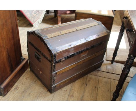 A vintage dome top wood and metal bound trunk