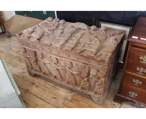 A carved African hardwood trunk, carved figures throughout