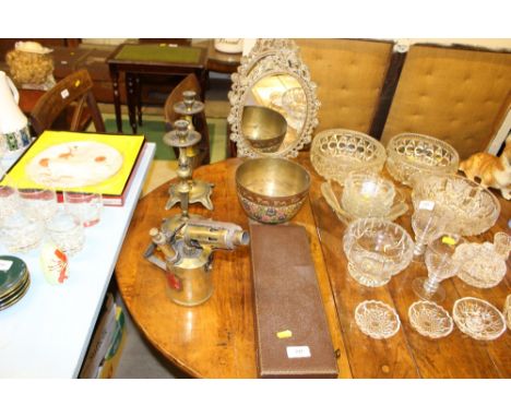 A three piece horn handled carving set; two brass framed mirrors; a pair of brass candlesticks; a blow lamp etc.