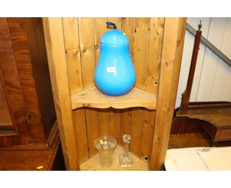 A blue glass pot and cover in the form of a pear together with a moulded glass vase and candlestick