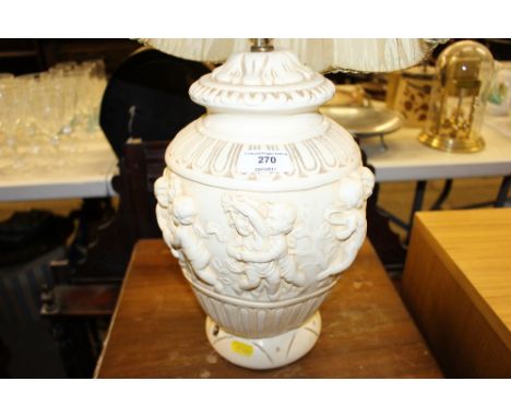 A figural decorated table lamp and shade