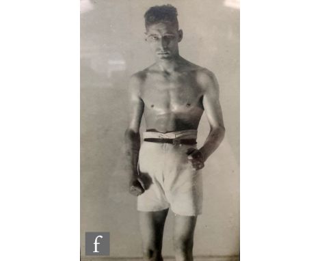 MONTAGUE GLOVER (1898-1983) - Portrait of an athletic young man wearing WWI riding breeches and boots, monochrome photograph,