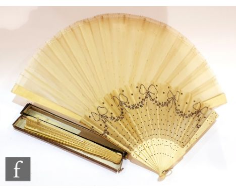 A 19th Century carved and pierced ivory fan, the centre with a monogram within exotic birds and sashes, each stick finely wor