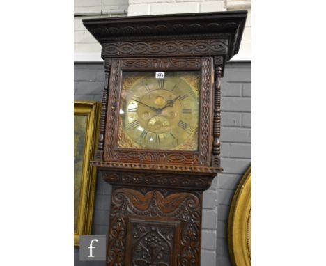 A 19th Century later foliate carved oak cased eight day strike long case clock, brass dial marked Richard Midgley, below cadd