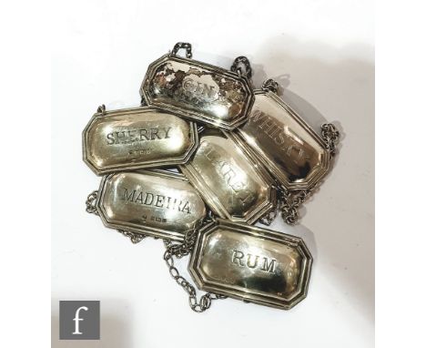 A composed set of six assorted canted rectangular decanter labels, madeira, claret, sherry, whisky, gin and rum, various styl