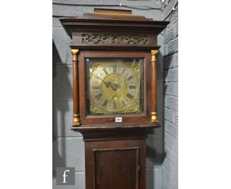 An oak cased thirty hour strike long case clock brass and silvered dial marked George Booth, Manchester below fret work friez