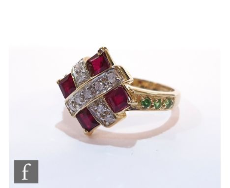 A 9ct hallmarked ruby, diamond and emerald ring, central cross of pave set diamonds with a ruby to each corner and emerald se