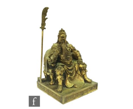 A contemporary cast metal figure of a Japanese seated warrior raised on square plinth base, the figure seated and reading a m