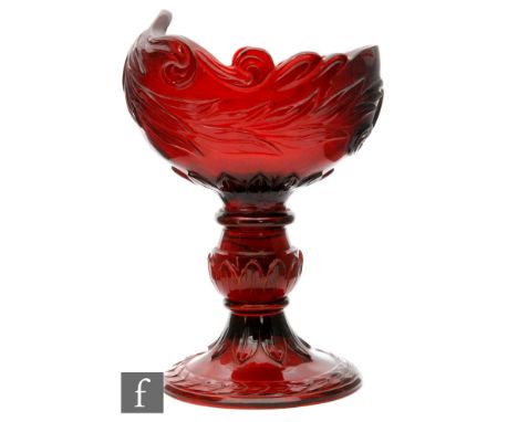 A large 19th Century ruby glass table salt, probably Russian of boat form with deeply carved foliate scrolls and laurel leave