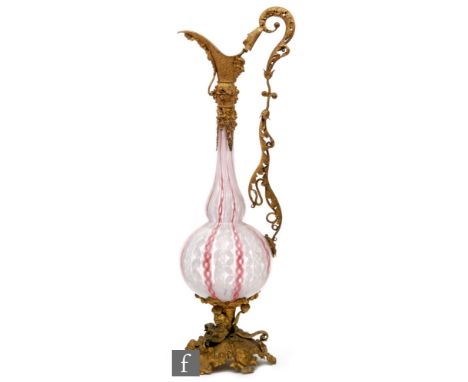 A late 19th Century Venetian glass decanter in gilt metal mounts, globe and shaft form with internal lattachino spirals and r
