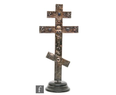 A Russian white metal cross with a figure of Christ, to each side mounted and inset with coloured cabochon stones on a turned
