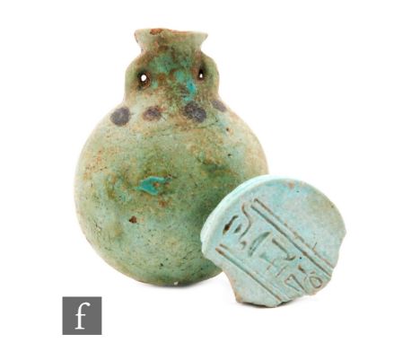 An Egyptian late dynastic faience ?pilgrim? flask with two lugs and black dot decoration, 8cm and an Egyptian faience roundel